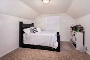 Upstairs bedroom #1 featuring lofted ceiling