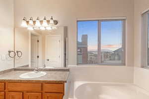 Bathroom with vanity and a bath