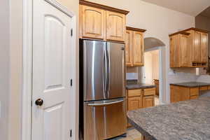 Kitchen featuring stainless steel fridge and light tile patterned flooring