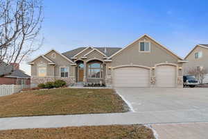 View of front facade featuring a garage and a front yard