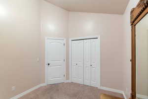 Unfurnished bedroom with carpet flooring and a closet