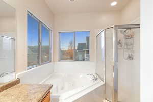 Bathroom featuring independent shower and bath and vanity