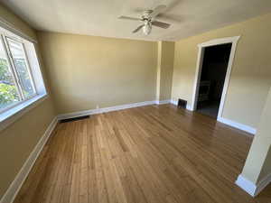 Unfurnished room with ceiling fan, hardwood / wood-style floors, and a textured ceiling