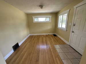 Interior space featuring a textured ceiling and light wood-type flooring