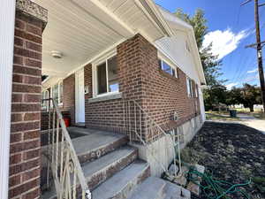 View of side of home featuring covered porch