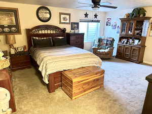 Bedroom with light carpet and ceiling fan