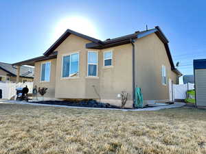 Rear view of house with a yard