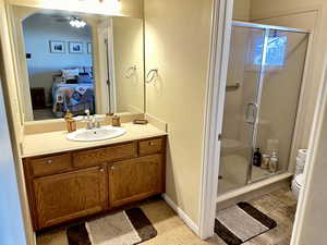 Bathroom featuring vanity, toilet, and walk in shower