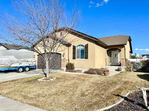 View of property exterior with an outdoor structure and a yard