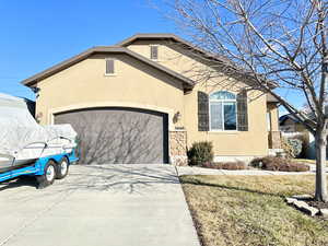 View of front facade featuring a garage and a front yard