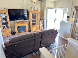 Living room featuring dark hardwood / wood-style floors and ceiling fan