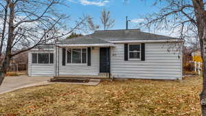 Bungalow-style home with a front lawn