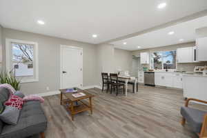 Living room with sink and light wood-type flooring