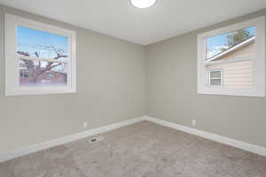 Spare room with light colored carpet