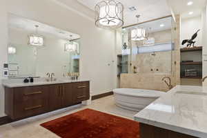 Bathroom featuring vanity and shower with separate bathtub