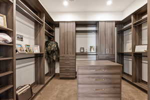 Walk in closet with light carpet