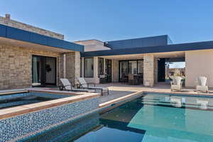 View of swimming pool with a jacuzzi and a patio area