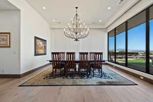 Dining area with a chandelier and light hardwood / wood-style floors