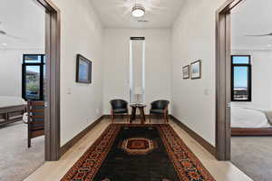 Living area with ceiling fan and light hardwood / wood-style floors