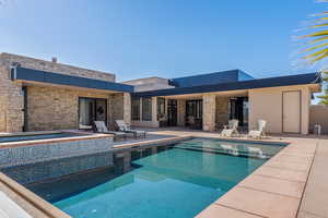 View of pool featuring a hot tub and a patio