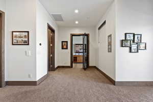 Hallway with carpet flooring