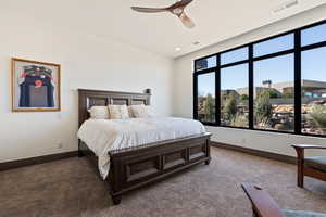 Bedroom featuring ceiling fan and carpet