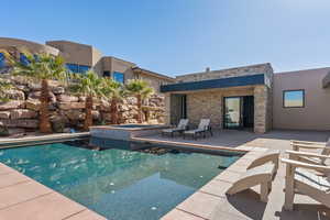 View of pool featuring a patio and an in ground hot tub