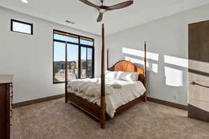 Carpeted bedroom with ceiling fan