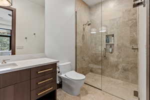 Bathroom with vanity, toilet, and walk in shower