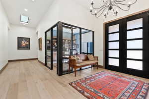 Entryway featuring a notable chandelier, light hardwood / wood-style flooring, and french doors