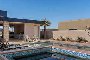 View of pool with area for grilling, a patio, and an in ground hot tub