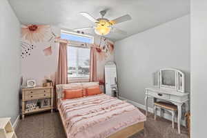 Bedroom featuring ceiling fan, carpet floors, and a textured ceiling