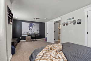 Bedroom with carpet and a textured ceiling