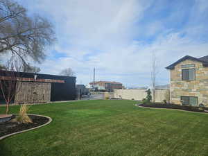View of yard featuring fence