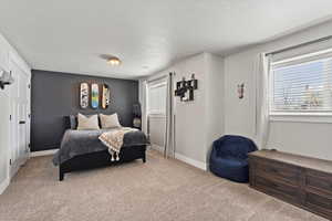 Carpeted bedroom featuring a textured ceiling