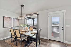 Dining area featuring dark wood-type flooring