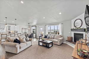 Living room featuring lofted ceiling, a textured ceiling, and light hardwood / wood-style floors