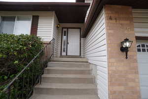 Doorway to property with a garage