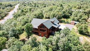View of subject property with a forest surrounding it