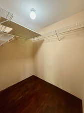 Huge bedroom closet with hardwood floors