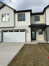 View of front of house featuring a garage and a front lawn