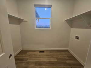 Laundry area featuring washer hookup and dark hardwood / wood-style floors