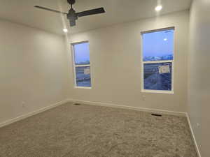 Empty room featuring carpet and ceiling fan