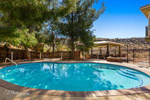 View of swimming pool with a mountain view