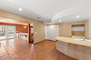 Kitchen featuring french doors, sink, and a textured ceiling