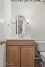 Bathroom featuring tile patterned floors, vanity, and toilet