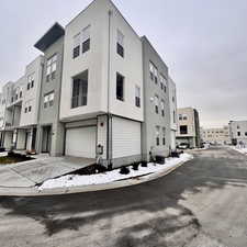 View of property featuring a garage and central AC unit