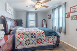 Bedroom with ceiling fan and carpet flooring