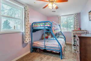 Bedroom with ceiling fan and carpet flooring