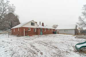 View of snow covered back of property